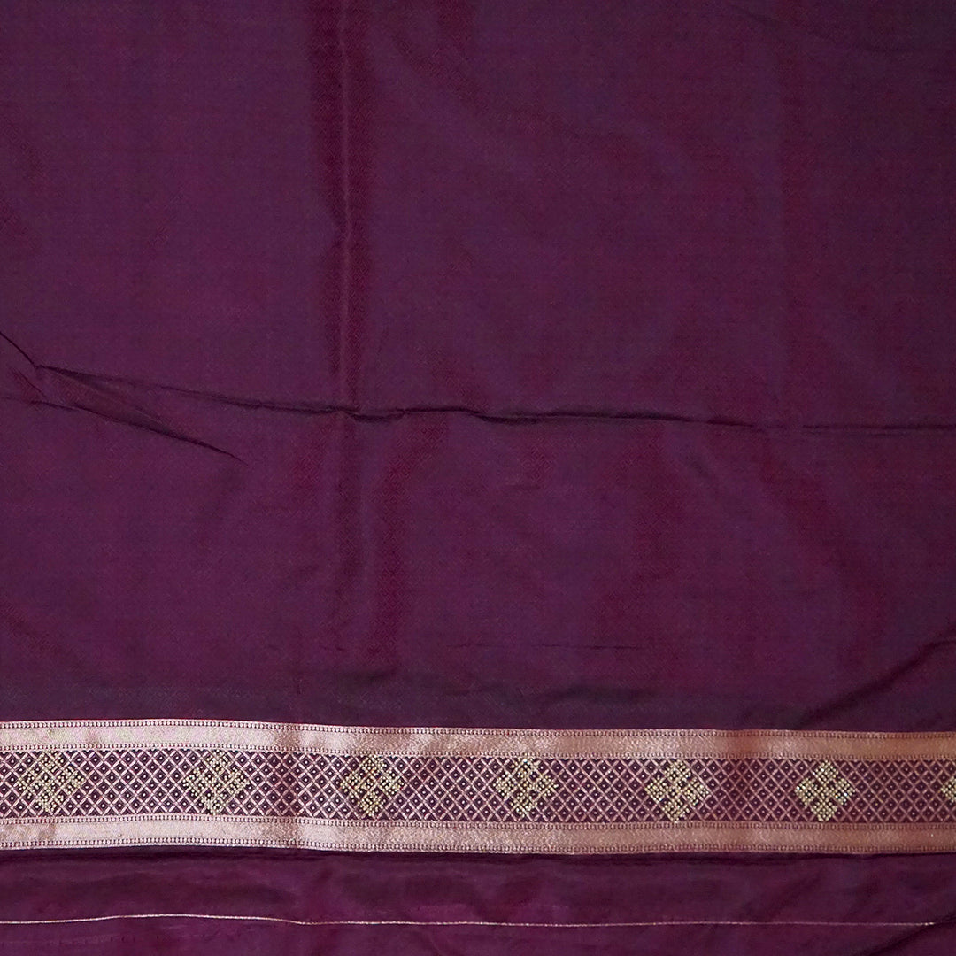Rithvi Satin Deep plum shade color adorned with intricate golden zari embroidery