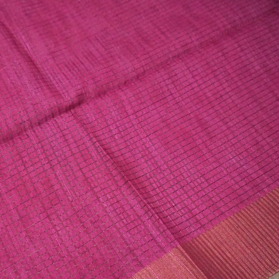 Harini Tussar in soft white base with colorful leaf motifs in blue, orange, and mustard, complemented by a rich maroon border.