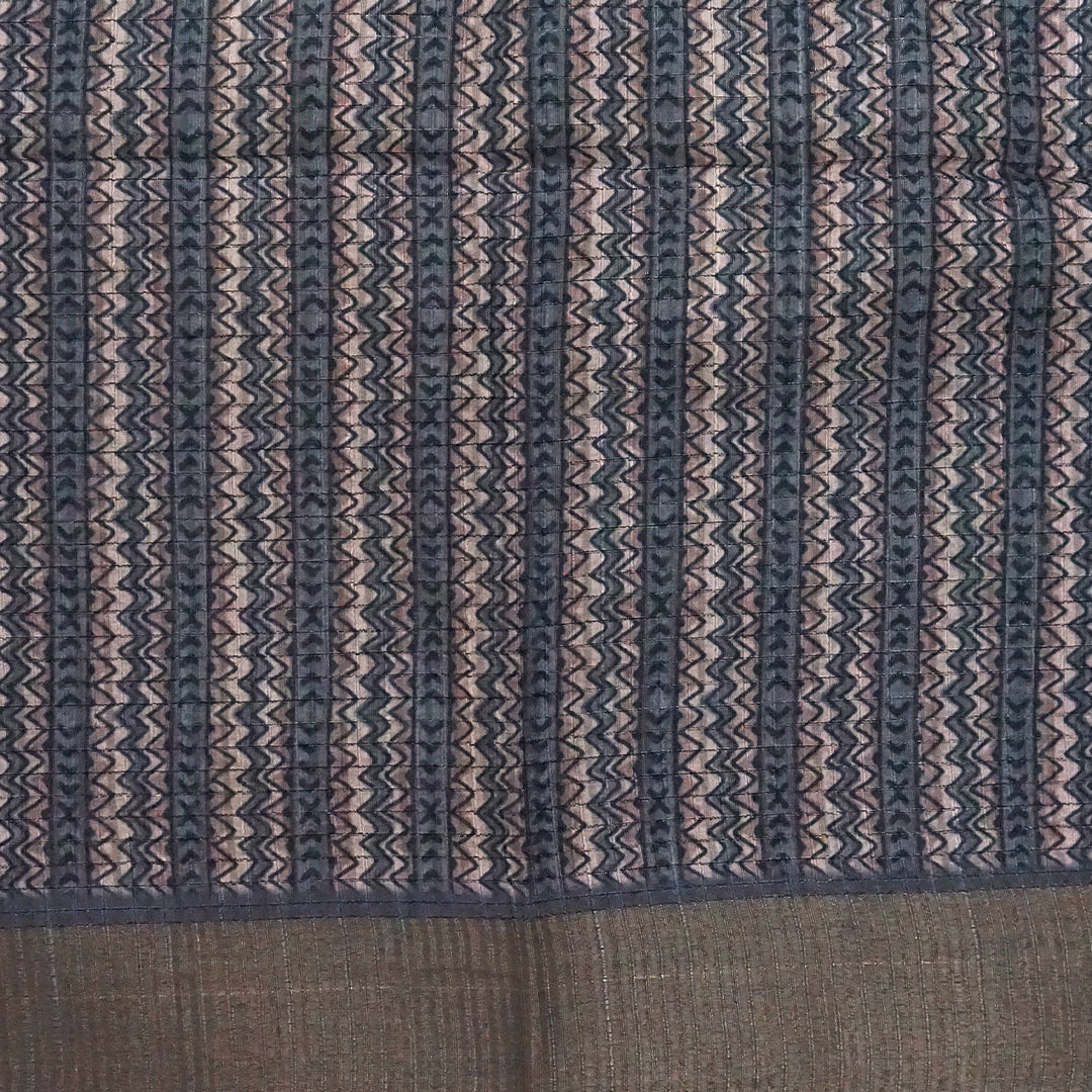 Harini Tussar in soft beige-grey base with a subtle checked pattern, beautifully accented by dark charcoal leaf motifs