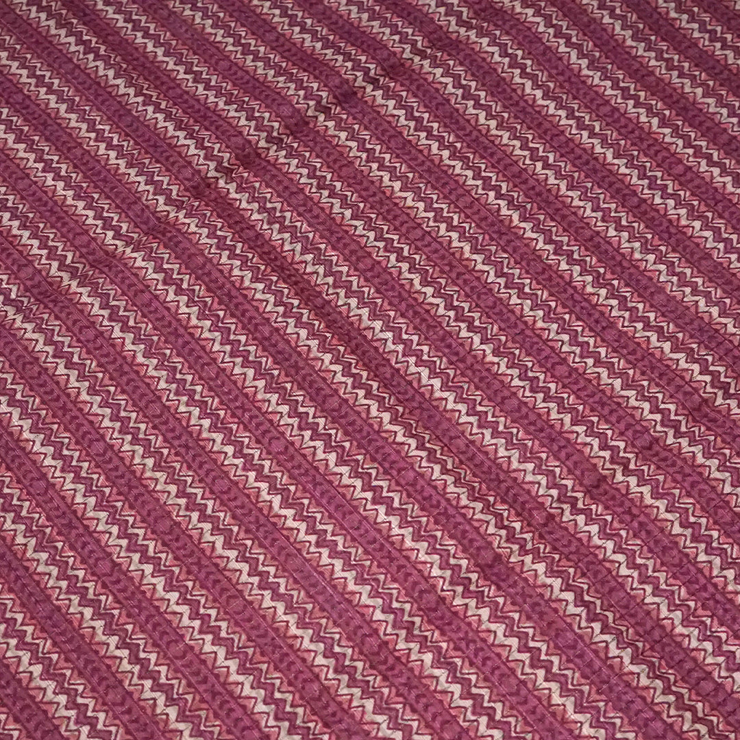 Harini Tussar in soft beige base with maroon leaf motifs and a matching brownish-maroon border, creating an elegant and earthy look.