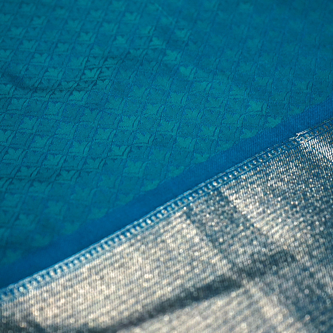 Hamsini Silk saree in Vibrant teal blue shade with a lustrous silk texture.