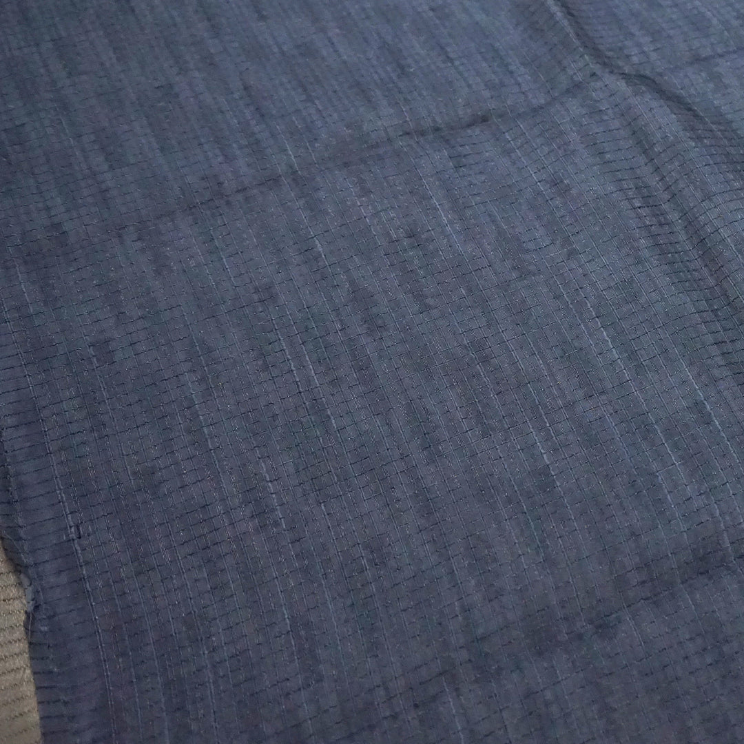 Harini Tussar in soft off-white base with multicolored leaf motifs in shades of pink, blue, and brown, beautifully complemented by an elegant metallic grey border.