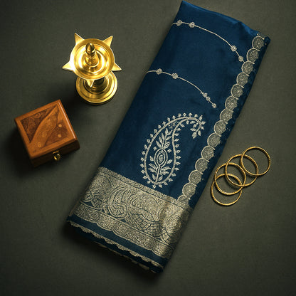 Ratnalekha silk saree in rich teal-blue base adorned with intricate gold zari work,