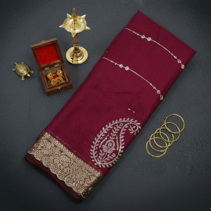 Ratnalekha Silk saree in rich wine-maroon base adorned with intricate gold zari embroidery