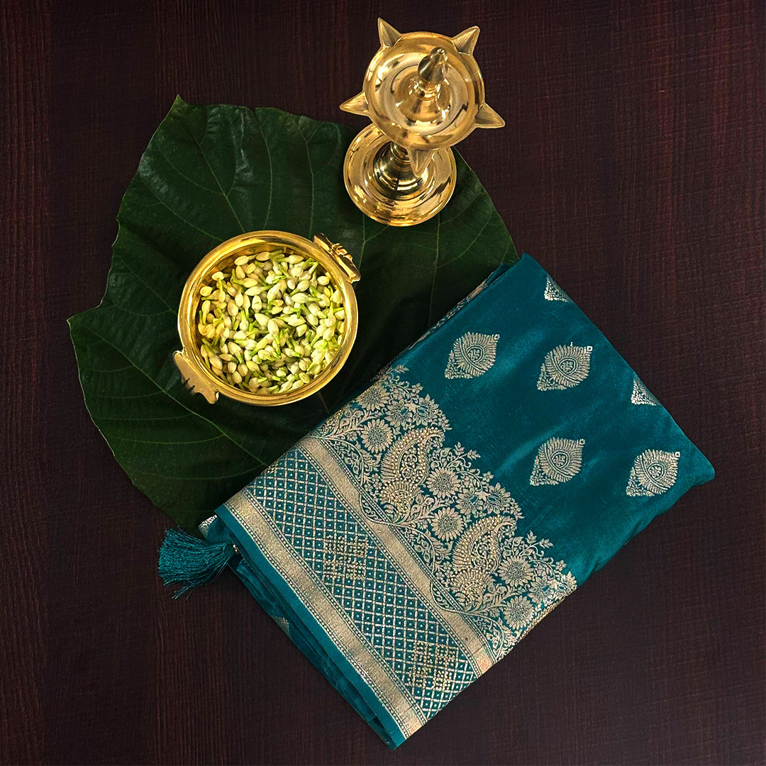 Rithvi Satin Teal blue color adorned with intricate golden zari embroidery