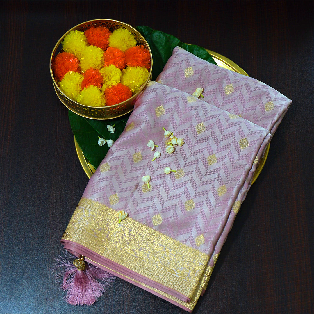 Vedika Silk saree in soft pastel pink shade with a luxurious golden zari weave.