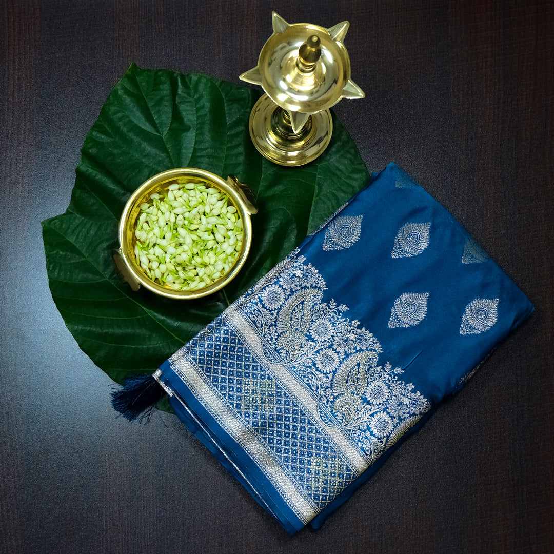 Rithvi Satin Aqua blue color adorned with intricate golden zari embroidery