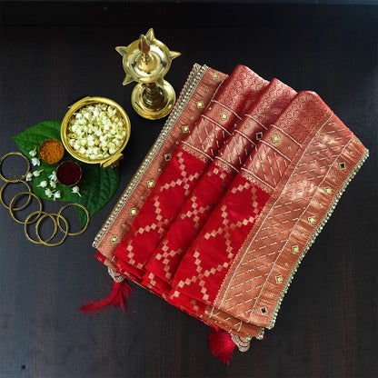 Samrudhi Silk saree in vibrant crimson red with a shimmering copper-toned border.