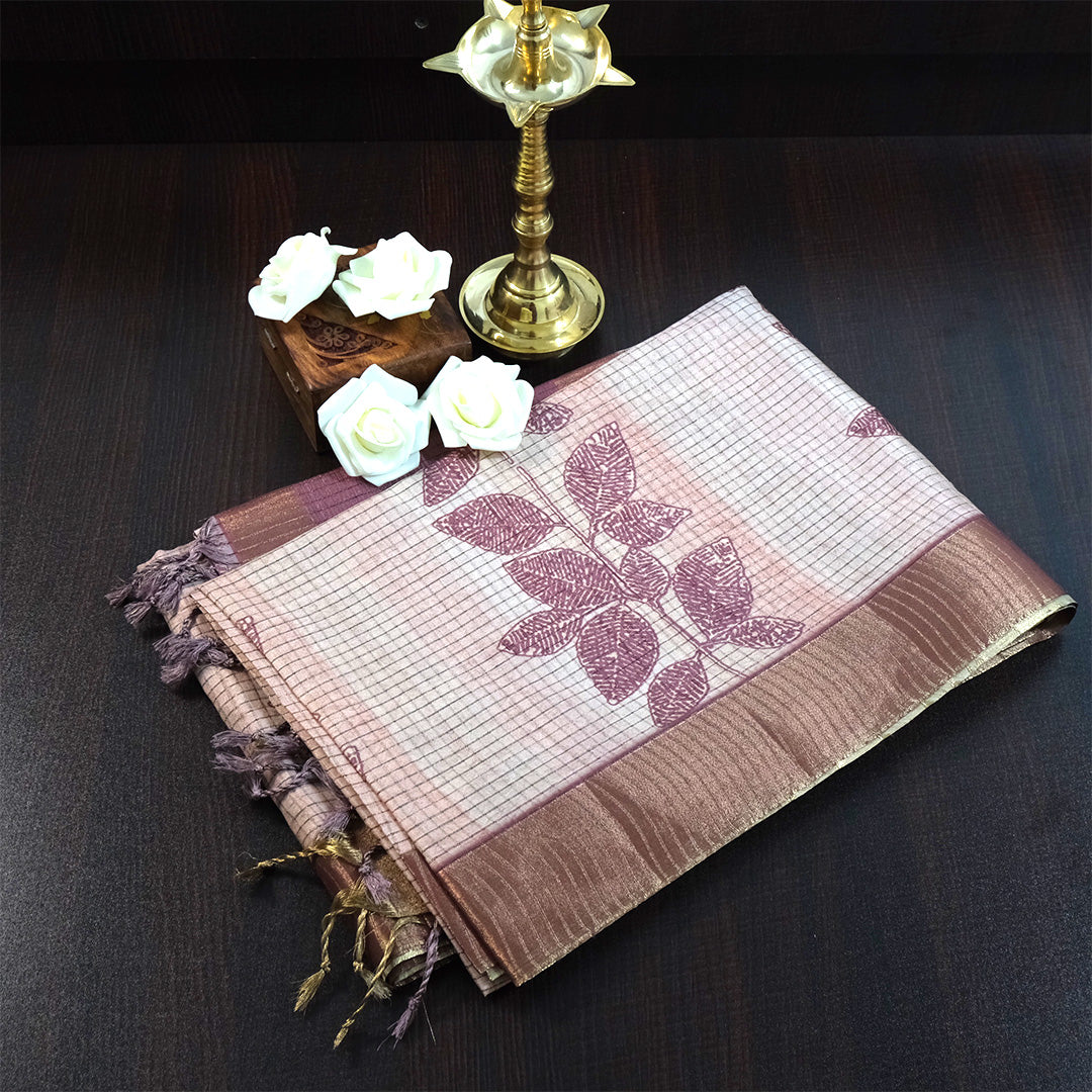 Harini Tussar in soft beige base with maroon leaf motifs and a matching brownish-maroon border, creating an elegant and earthy look.