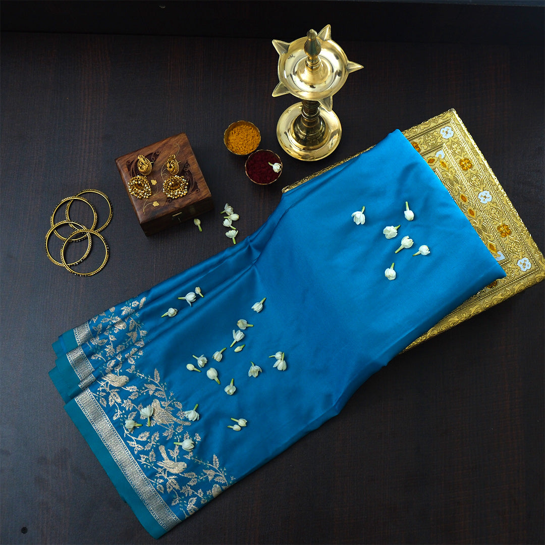 Hamsini Silk saree in Vibrant teal blue shade with a lustrous silk texture.