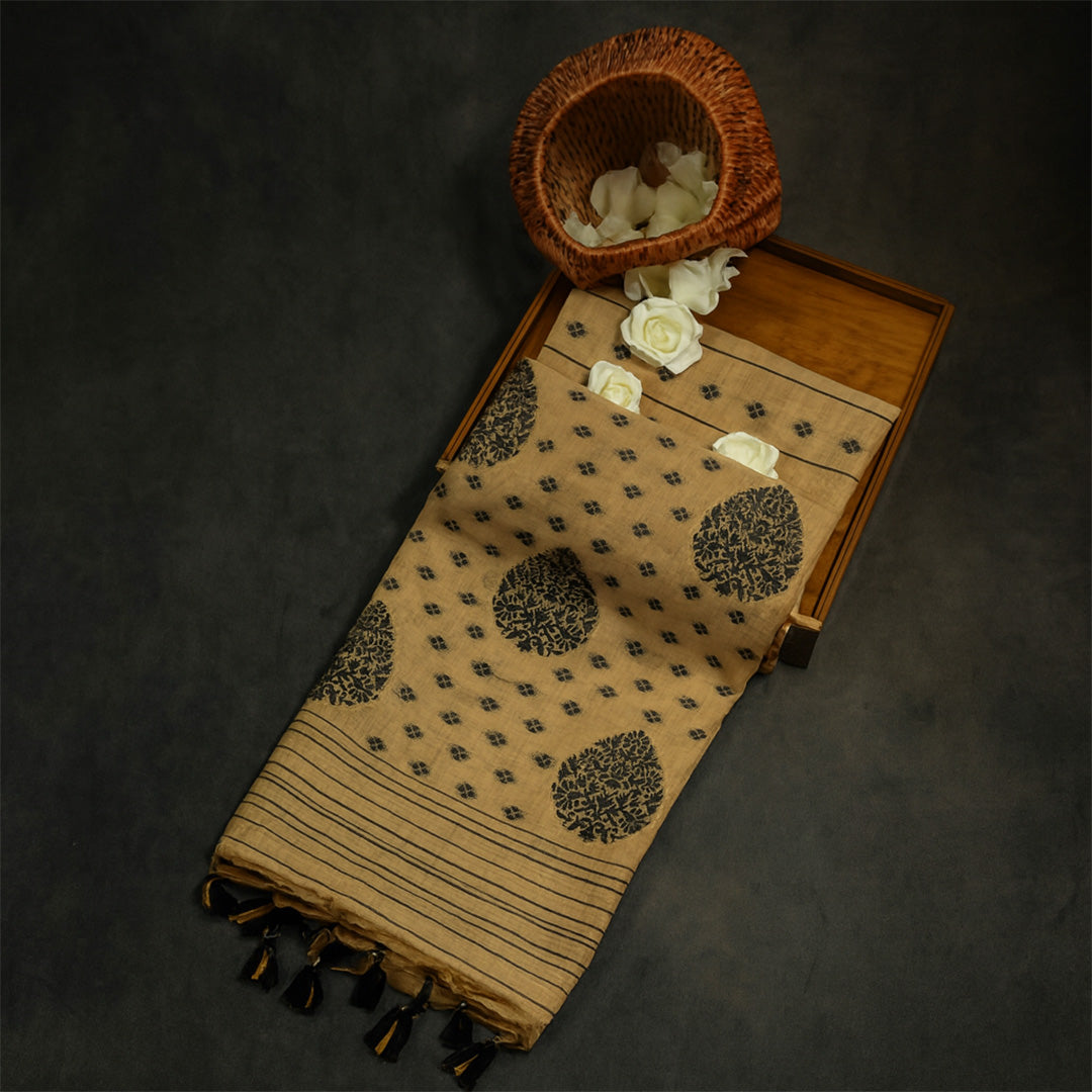 Beige Ishvani Tussar saree with black tassels