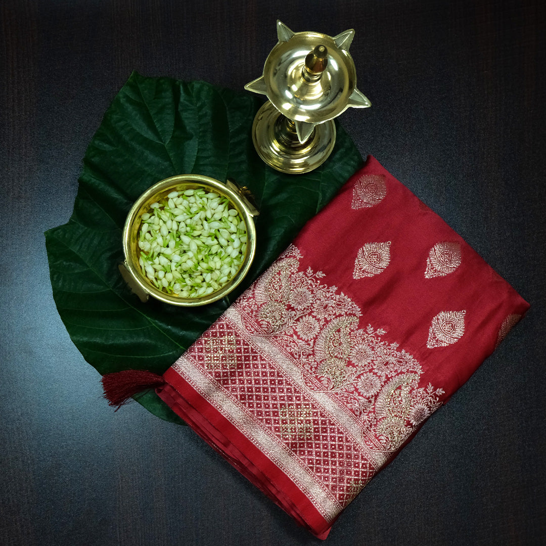 Rithvi Satin Deep red color adorned with intricate golden zari embroidery