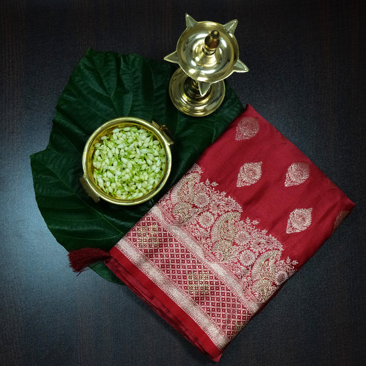 Rithvi Satin Deep red color adorned with intricate golden zari embroidery