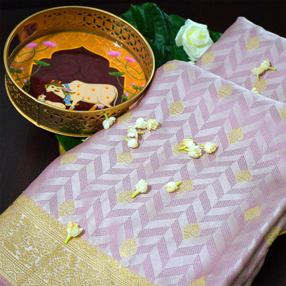 Vedika Silk saree in soft pastel pink shade with a luxurious golden zari weave.