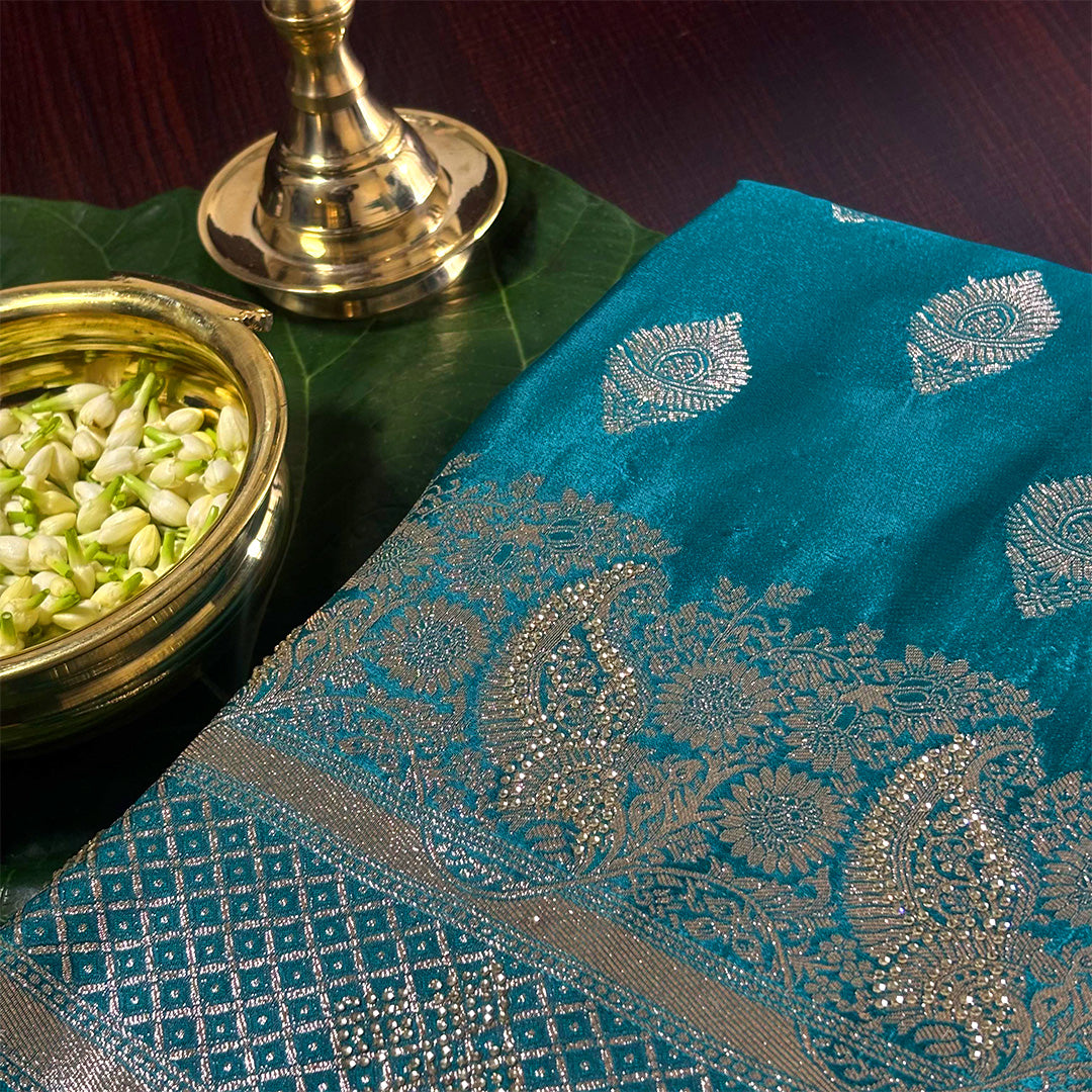 Rithvi Satin Teal blue color adorned with intricate golden zari embroidery