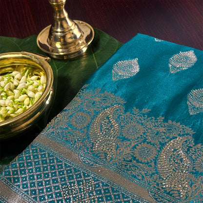Rithvi Satin Teal blue color adorned with intricate golden zari embroidery