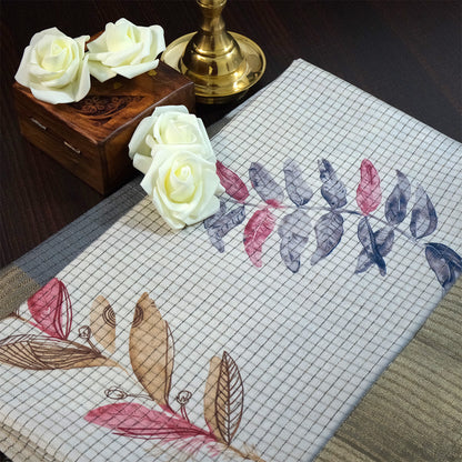 Harini Tussar in soft off-white base with multicolored leaf motifs in shades of pink, blue, and brown, beautifully complemented by an elegant metallic grey border.