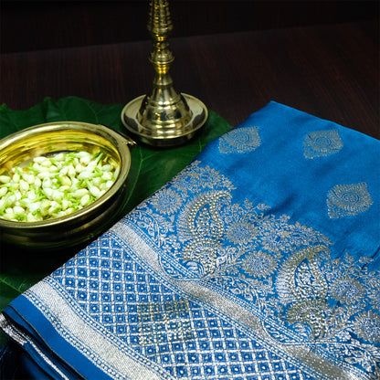 Rithvi Satin Aqua blue color adorned with intricate golden zari embroidery