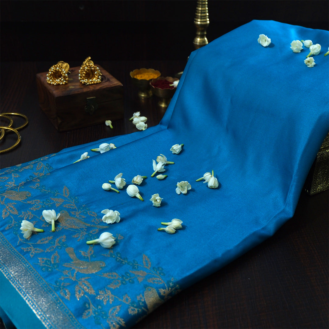 Hamsini Silk saree in Vibrant teal blue shade with a lustrous silk texture.