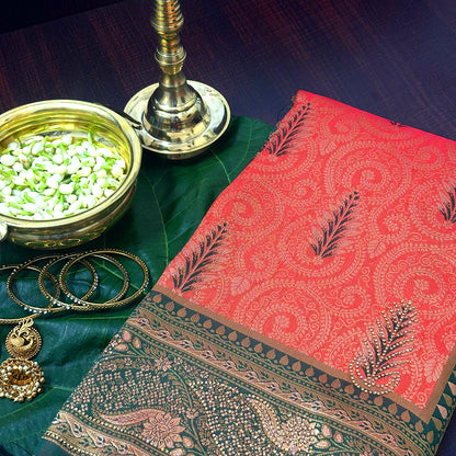 Madhur Bela rich coral-orange shade with a golden undertone.