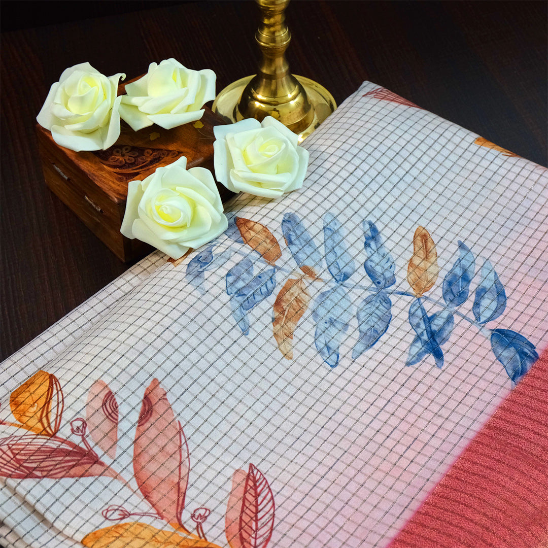 Harini Tussar in soft white base with colorful leaf motifs in blue, orange, and mustard, complemented by a rich maroon border.