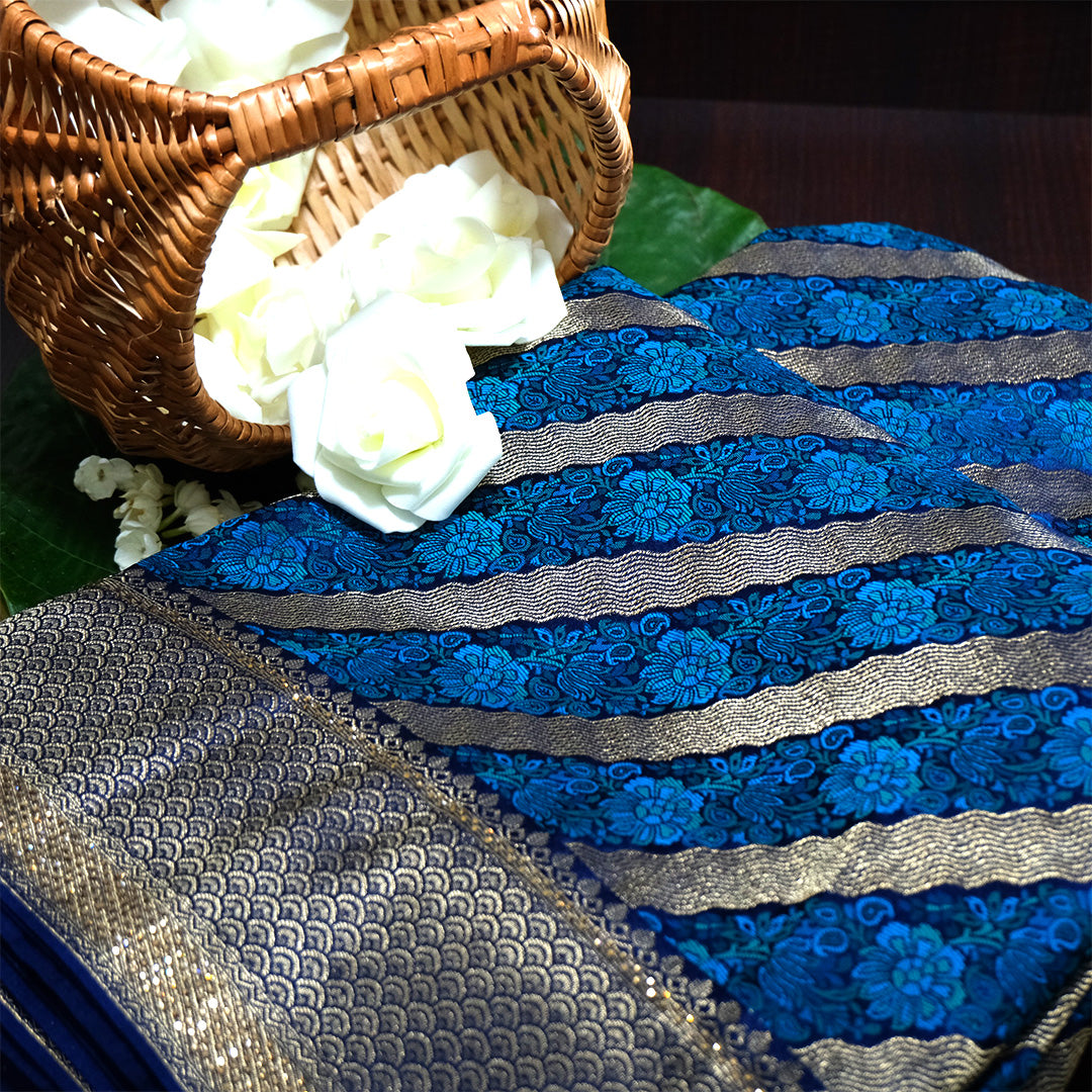 Megha Silk saree in rich royal blue with alternating metallic gold zari stripes.