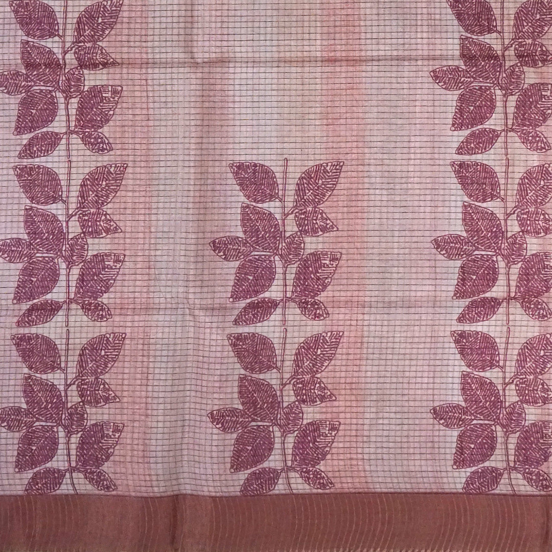 Harini Tussar in soft beige base with maroon leaf motifs and a matching brownish-maroon border, creating an elegant and earthy look.