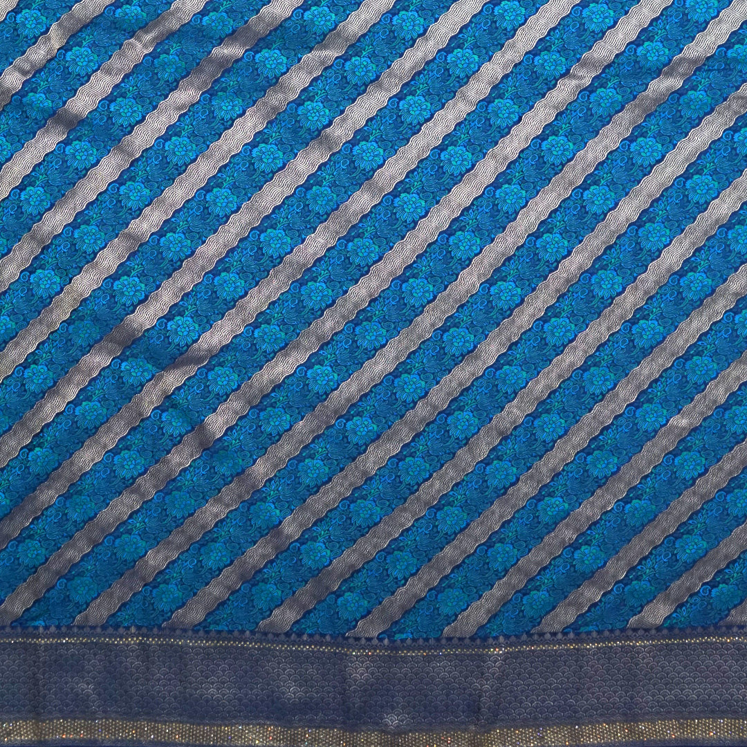 Megha Silk saree in rich royal blue with alternating metallic gold zari stripes.