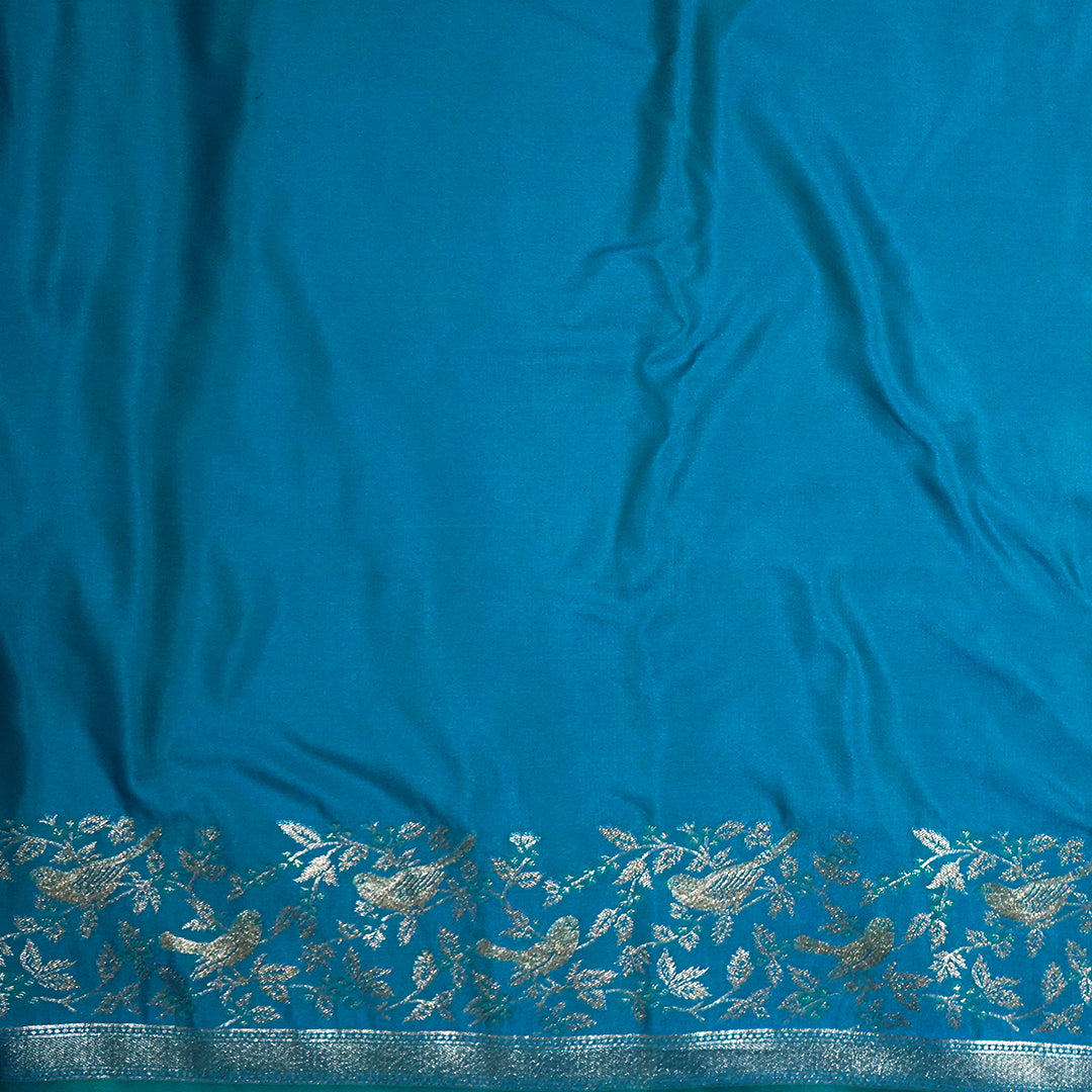Hamsini Silk saree in Vibrant teal blue shade with a lustrous silk texture.
