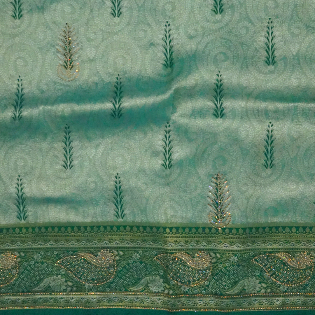 Madhur Bela soothing teal-green hue shade with a golden undertone.