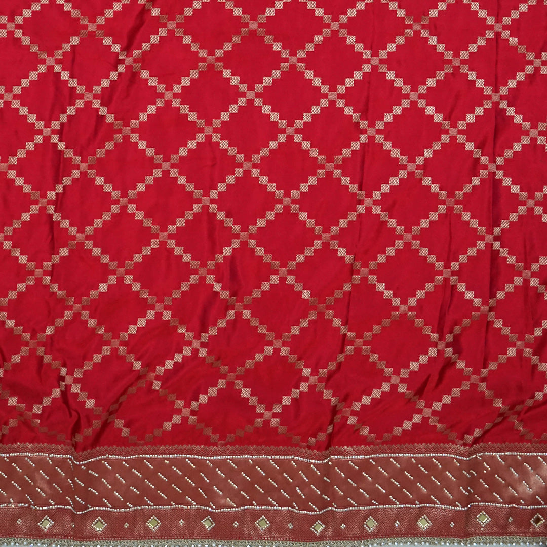 Samrudhi Silk saree in vibrant crimson red with a shimmering copper-toned border.
