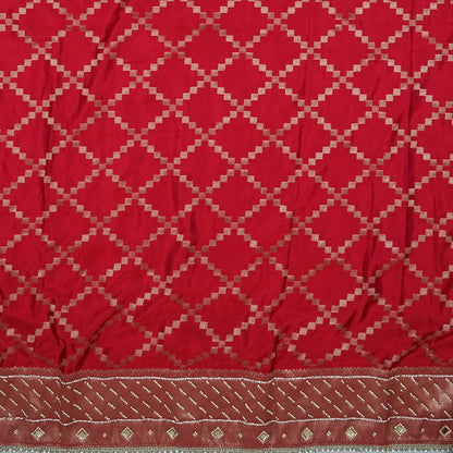 Samrudhi Silk saree in vibrant crimson red with a shimmering copper-toned border.