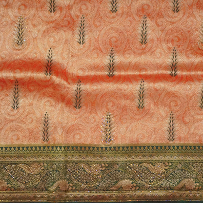 Madhur Bela rich coral-orange shade with a golden undertone.