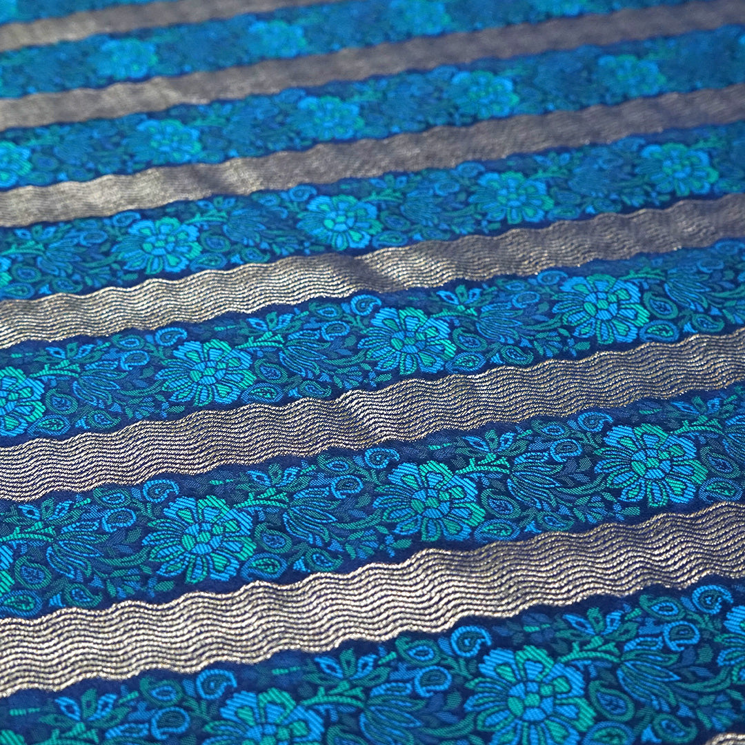 Megha Silk saree in rich royal blue with alternating metallic gold zari stripes.