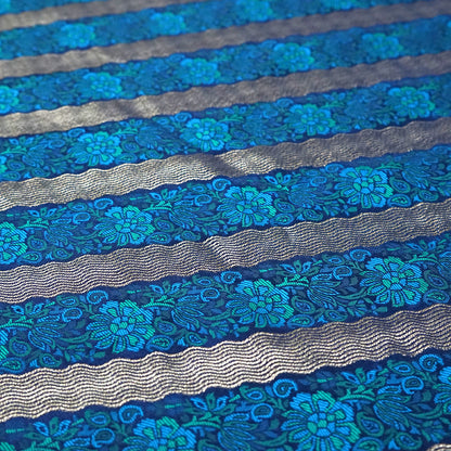 Megha Silk saree in rich royal blue with alternating metallic gold zari stripes.