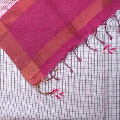 Harini Tussar in soft white base with colorful leaf motifs in blue, orange, and mustard, complemented by a rich maroon border.