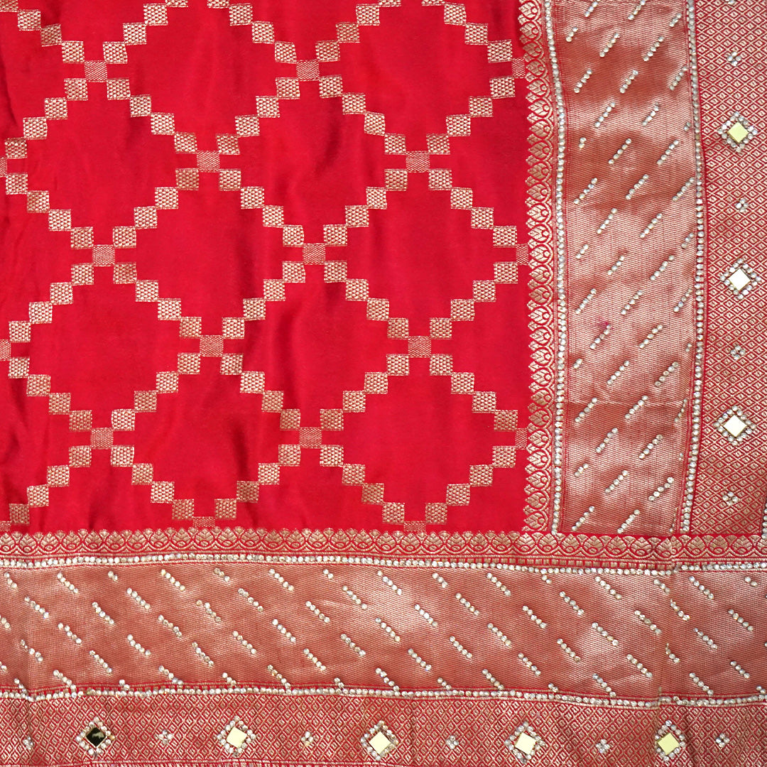 Samrudhi Silk saree in vibrant crimson red with a shimmering copper-toned border.