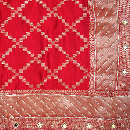 Samrudhi Silk saree in vibrant crimson red with a shimmering copper-toned border.