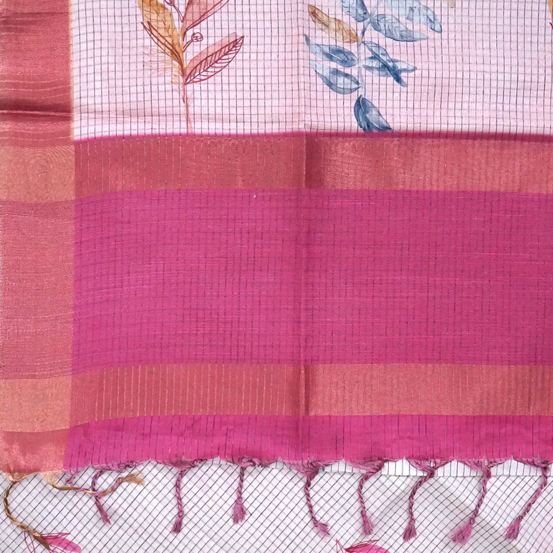 Harini Tussar in soft white base with colorful leaf motifs in blue, orange, and mustard, complemented by a rich maroon border.