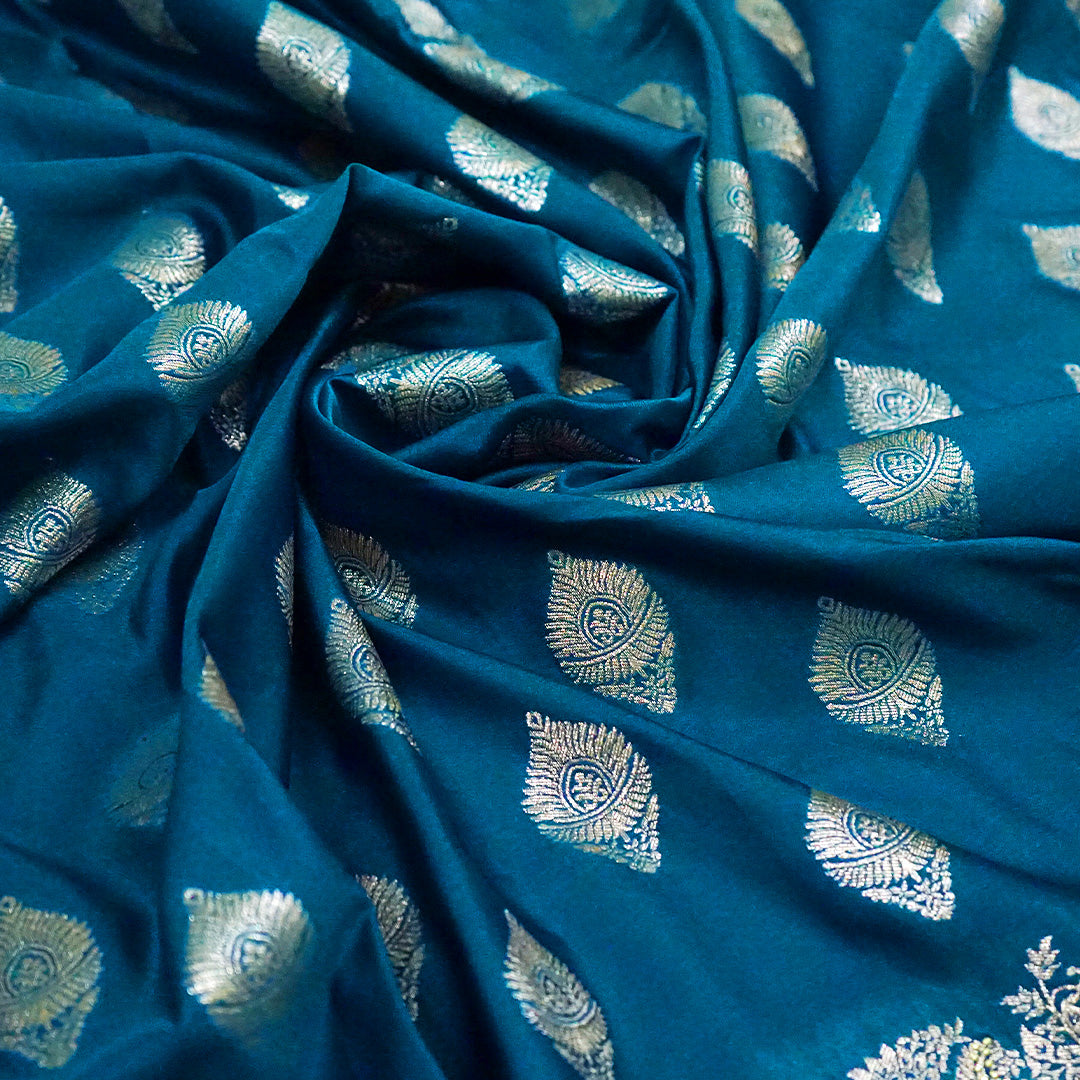Rithvi Satin Aqua blue color adorned with intricate golden zari embroidery