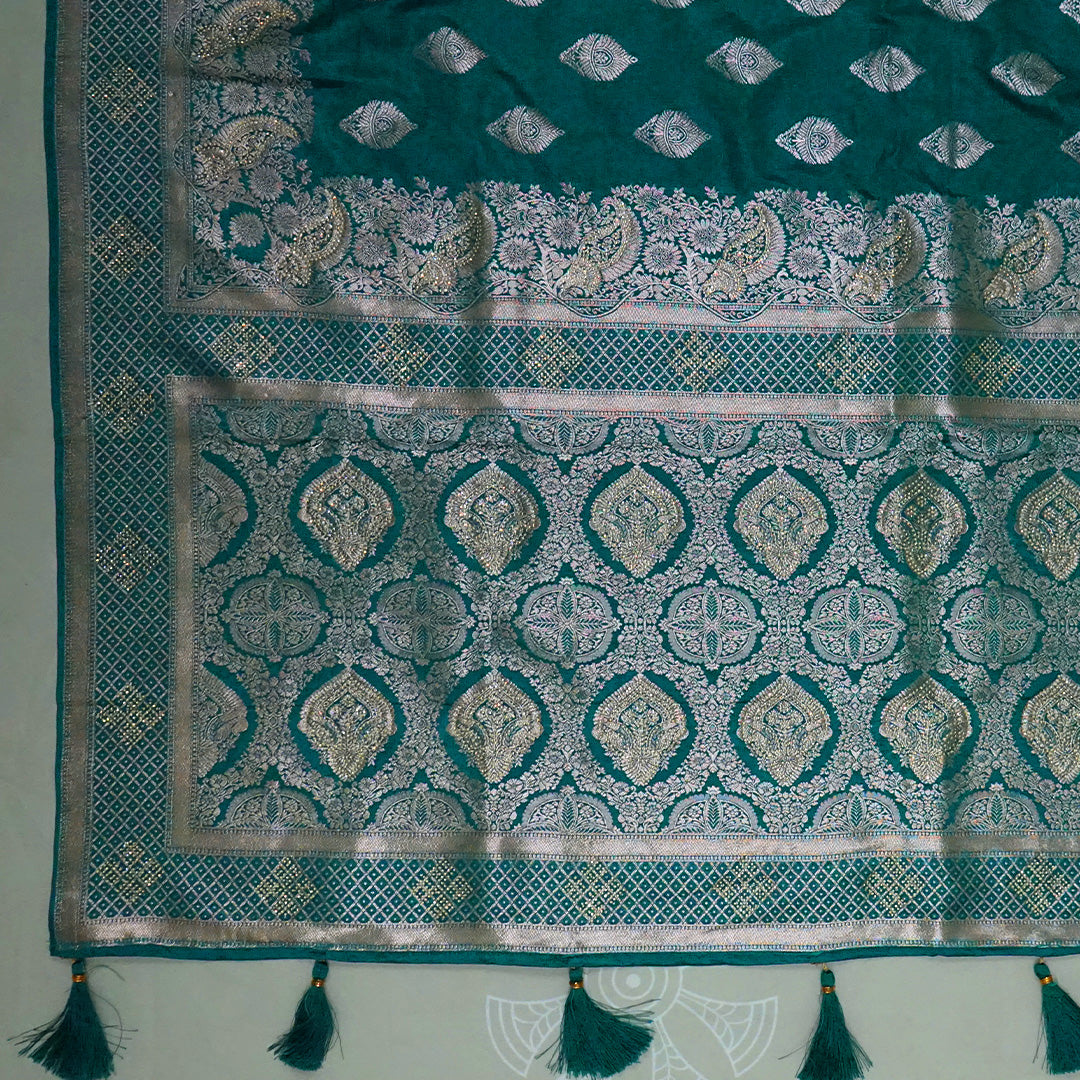Rithvi Satin Teal blue color adorned with intricate golden zari embroidery
