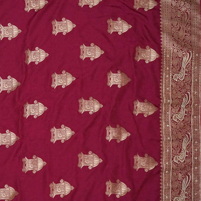 Royal Ratha Banarasi silk in deep maroon red shade, highlighted with rich golden zari motifs and an ornate golden border.