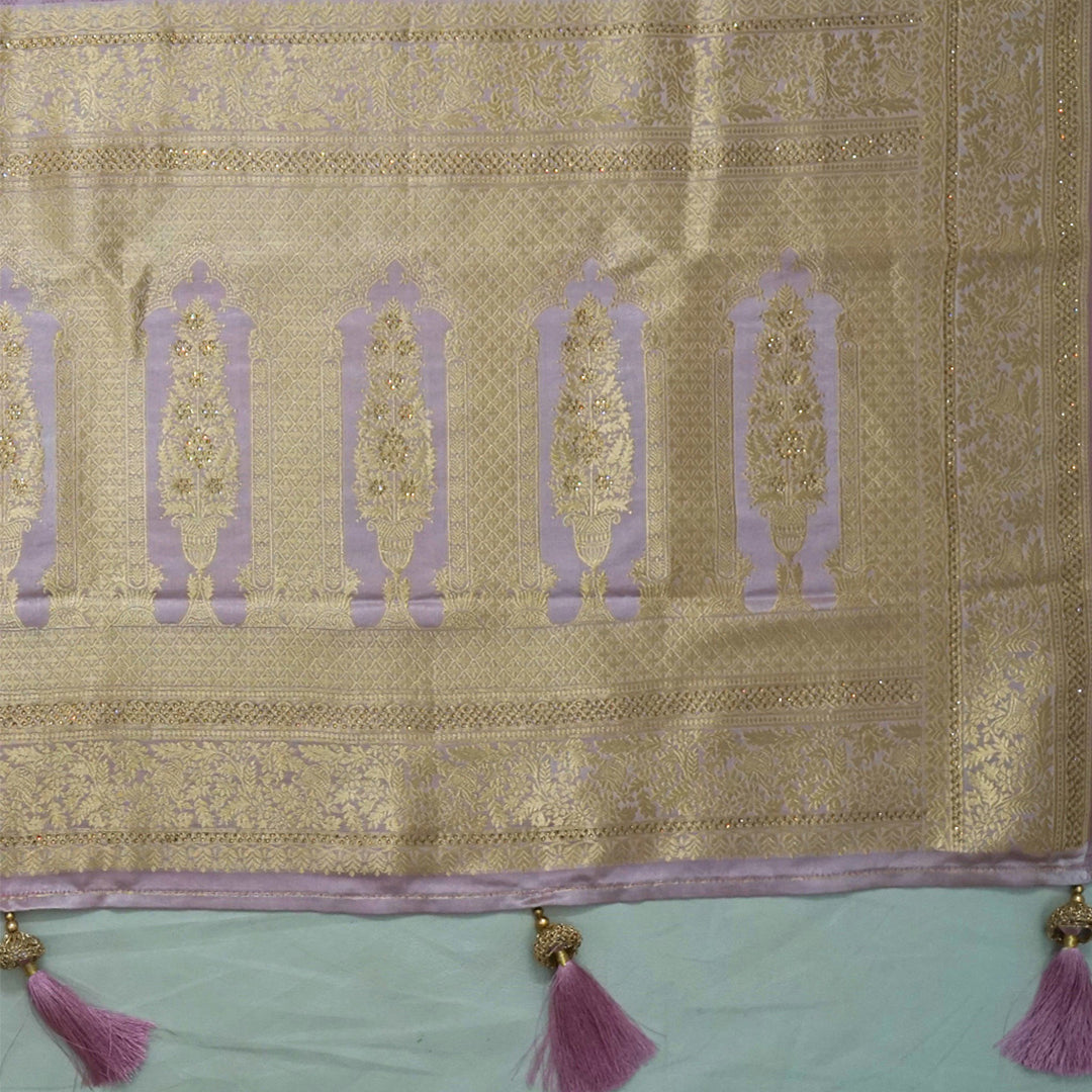 Vedika Silk saree in soft pastel pink shade with a luxurious golden zari weave.