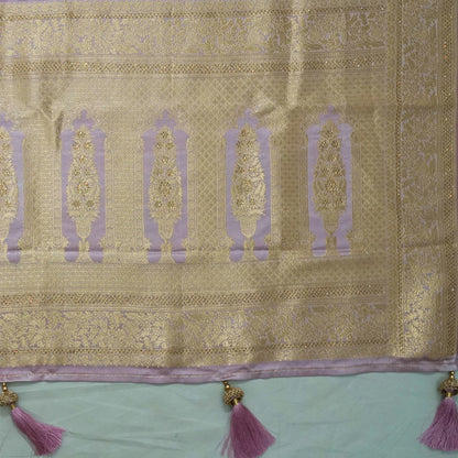 Vedika Silk saree in soft pastel pink shade with a luxurious golden zari weave.