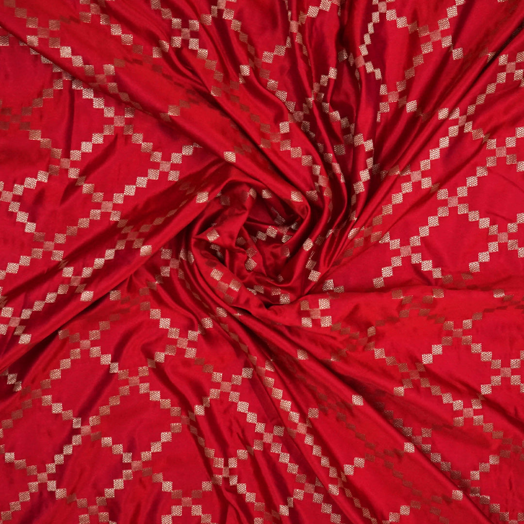 Samrudhi Silk saree in vibrant crimson red with a shimmering copper-toned border.