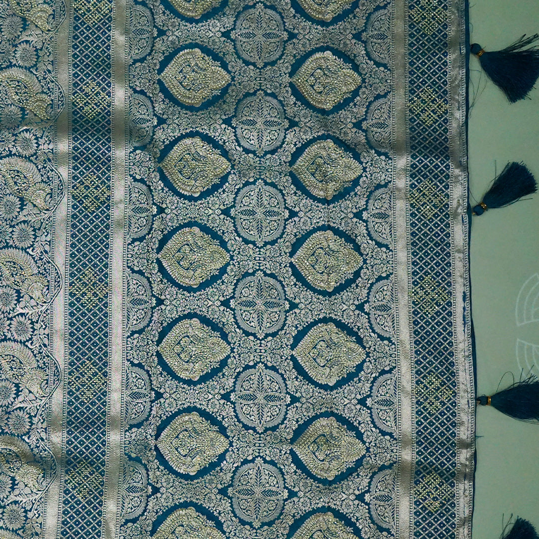 Rithvi Satin Aqua blue color adorned with intricate golden zari embroidery