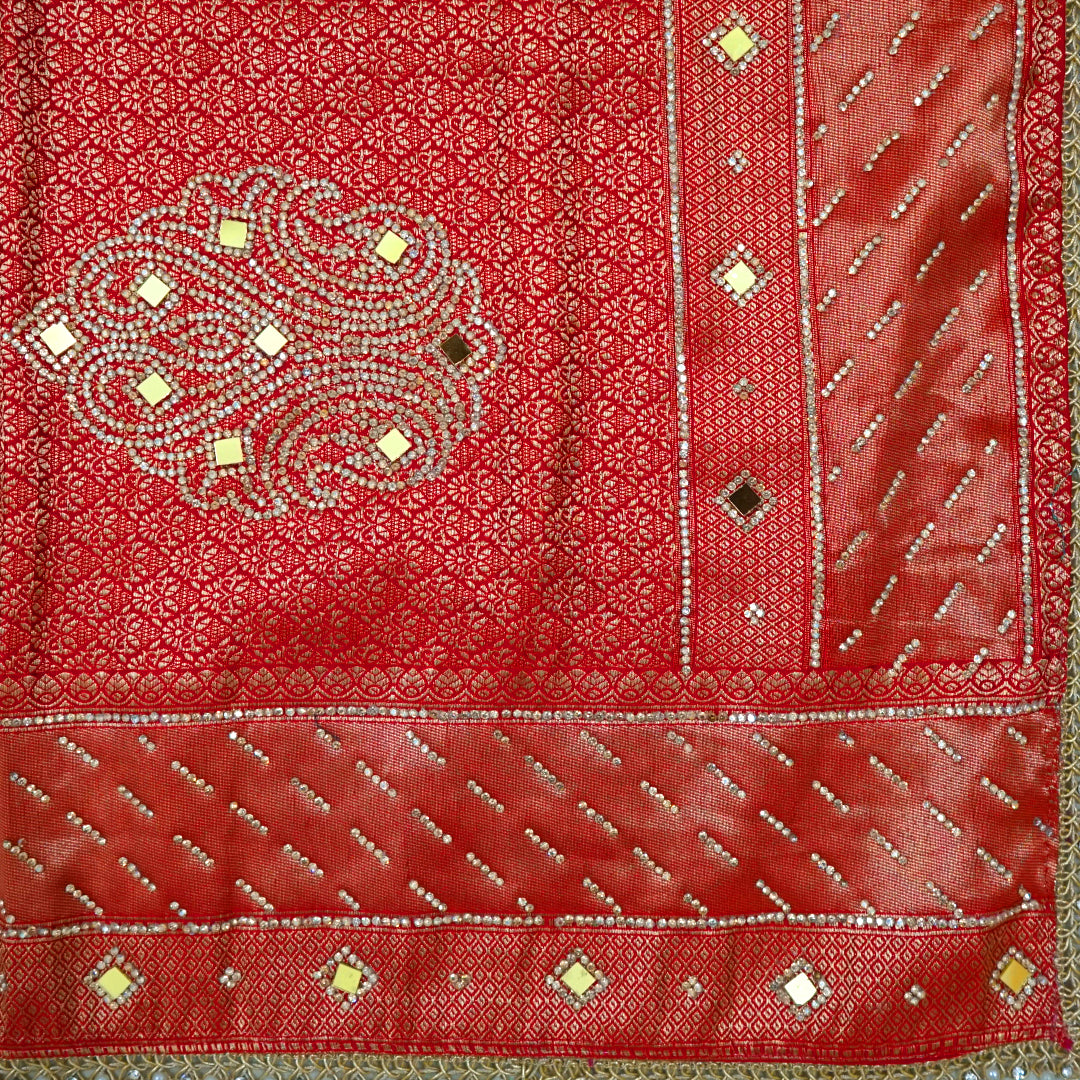Samrudhi Silk saree in vibrant crimson red with a shimmering copper-toned border.