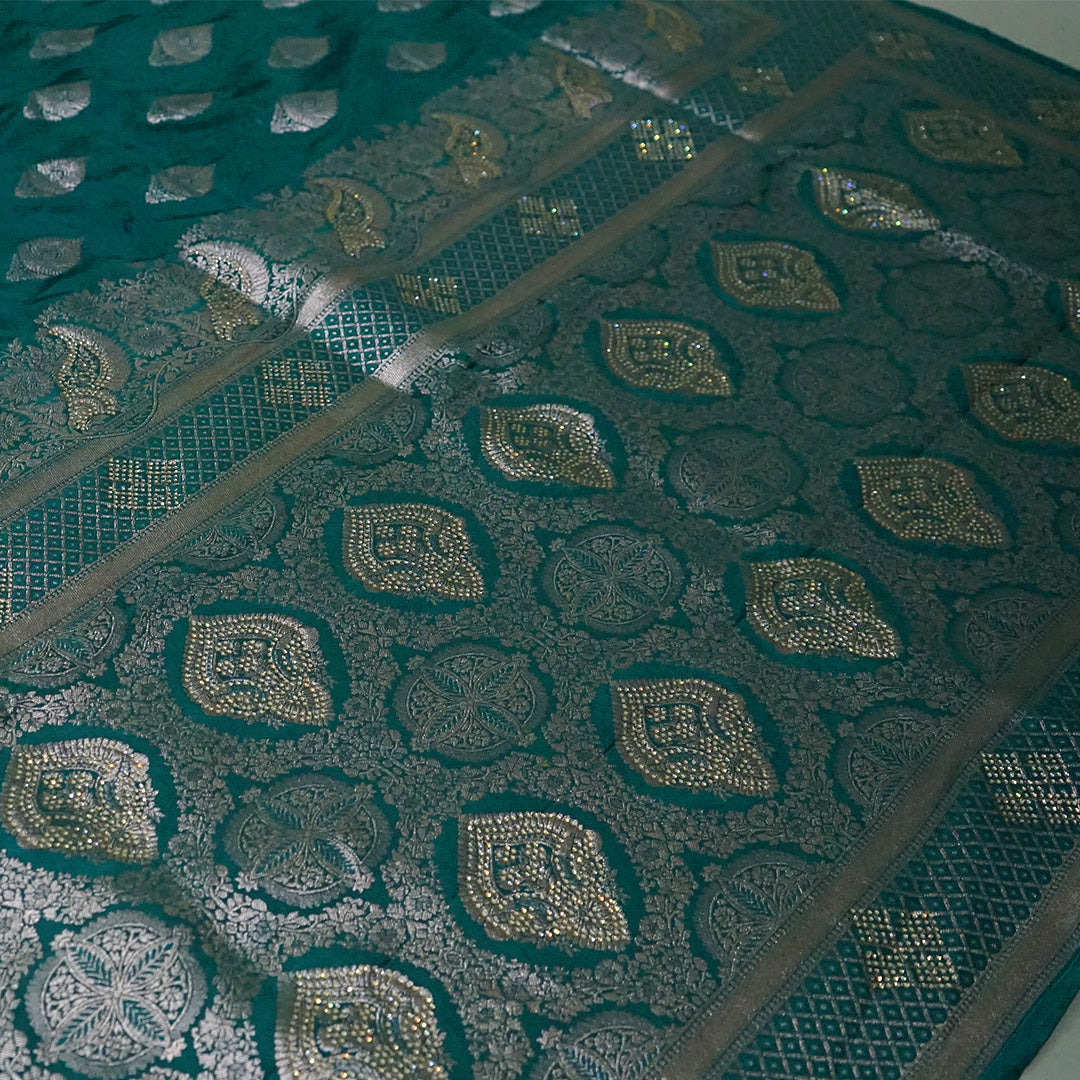 Rithvi Satin Teal blue color adorned with intricate golden zari embroidery