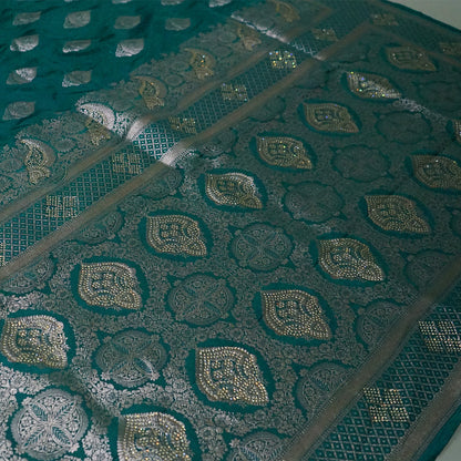 Rithvi Satin Teal blue color adorned with intricate golden zari embroidery