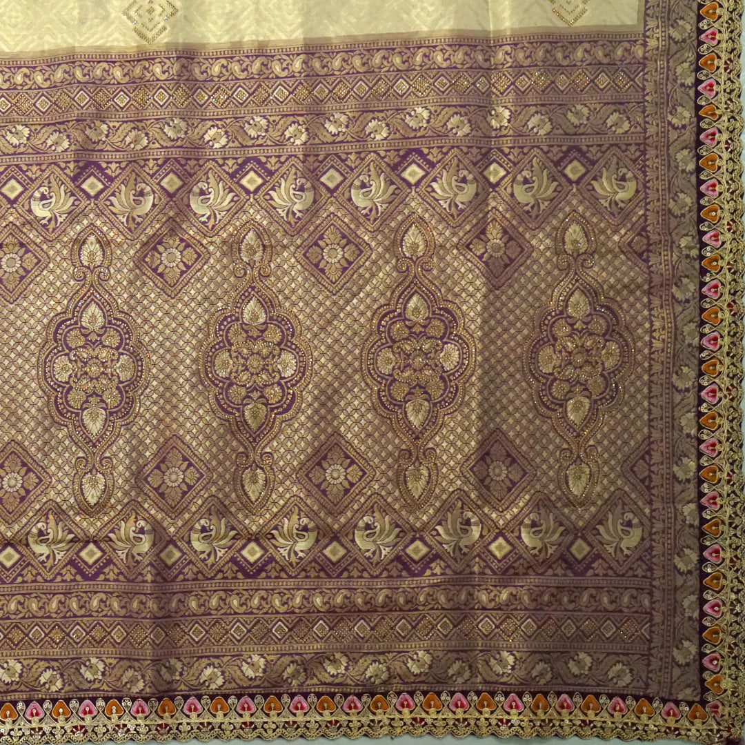 Golden cream Raj Virasat Silk saree with Deep purple base and heavy embroidery.
